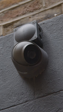 Vertical-Video-Close-Up-Of-Surveillance-Camera-Outside-Buildings-In-Mayfair-London-UK